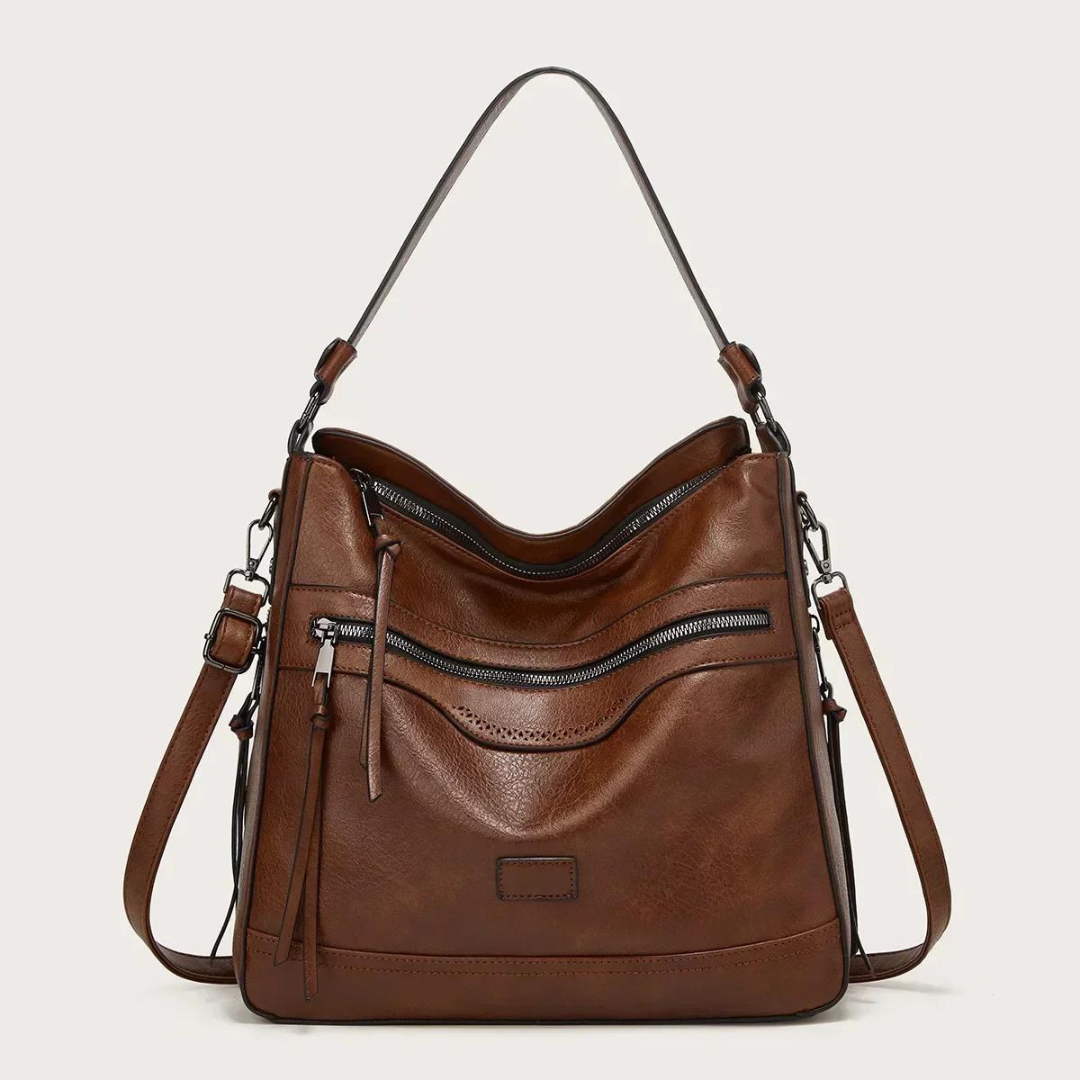 Braune Lederhandtasche mit Reißverschlusstaschen und verstellbarem Schulterriemen.