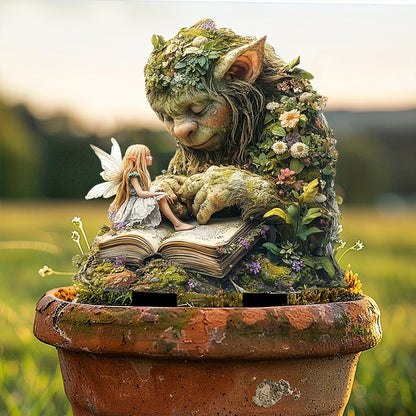 Troll mit Fee auf dem aufgeschlagenen Buch, in einem alten Terrakottatopf vor sonniger Wiese platziert. 11