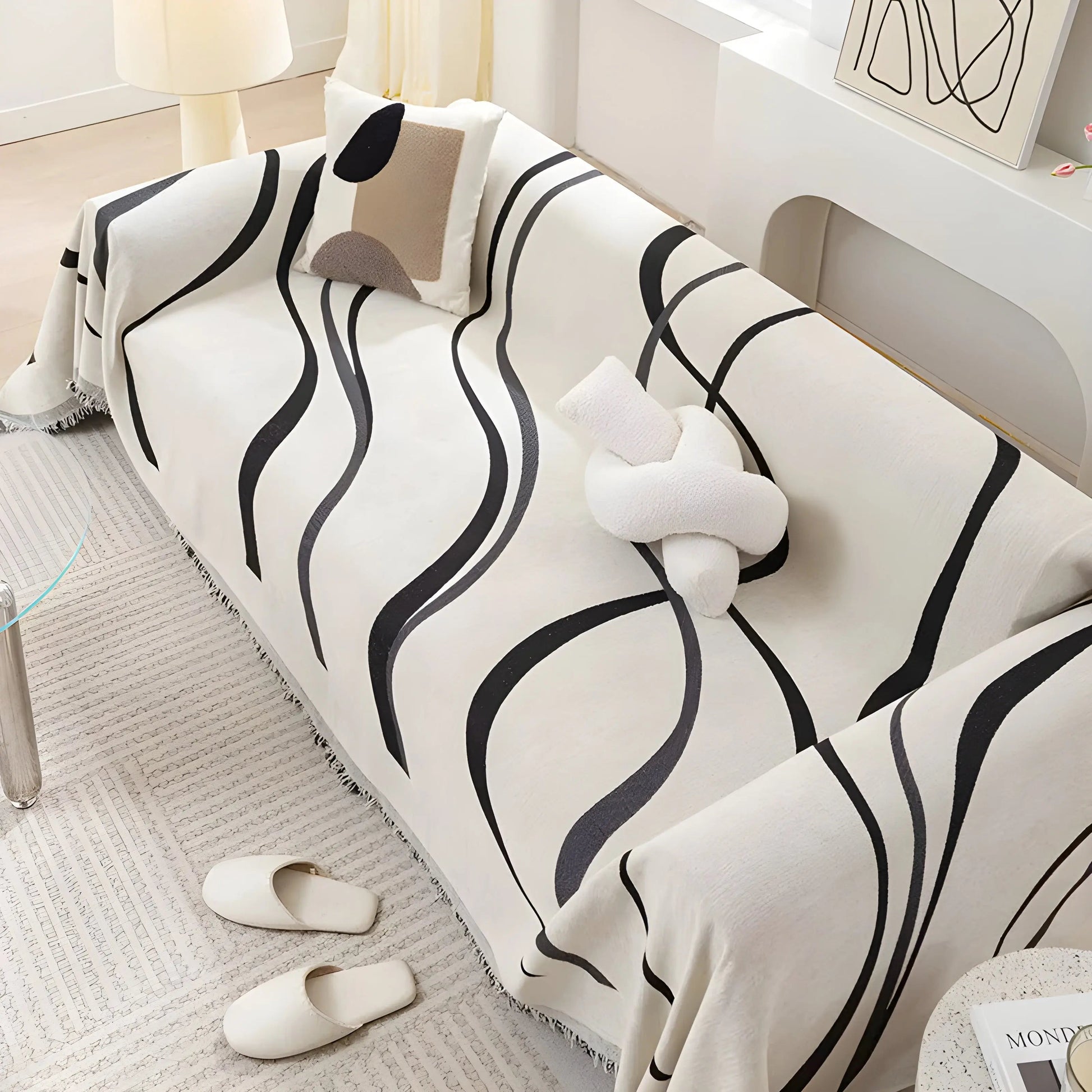 Schwarz-weiß gestreiftes Sofa mit Kissen, modernes Wohnzimmer, minimalistische Einrichtung.