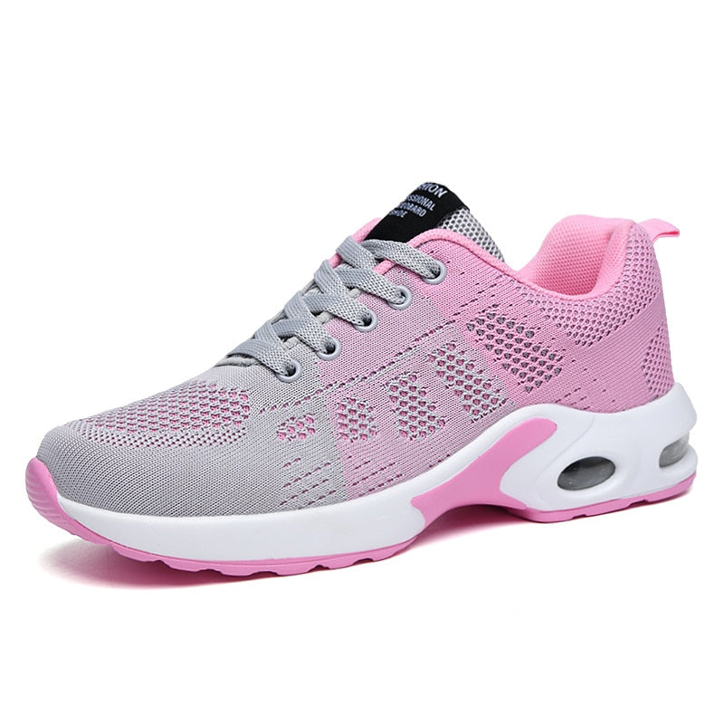Grauer und rosa Damen-Laufschuh, atmungsaktiv, Mesh-Obermaterial, sportlich, bequem.
