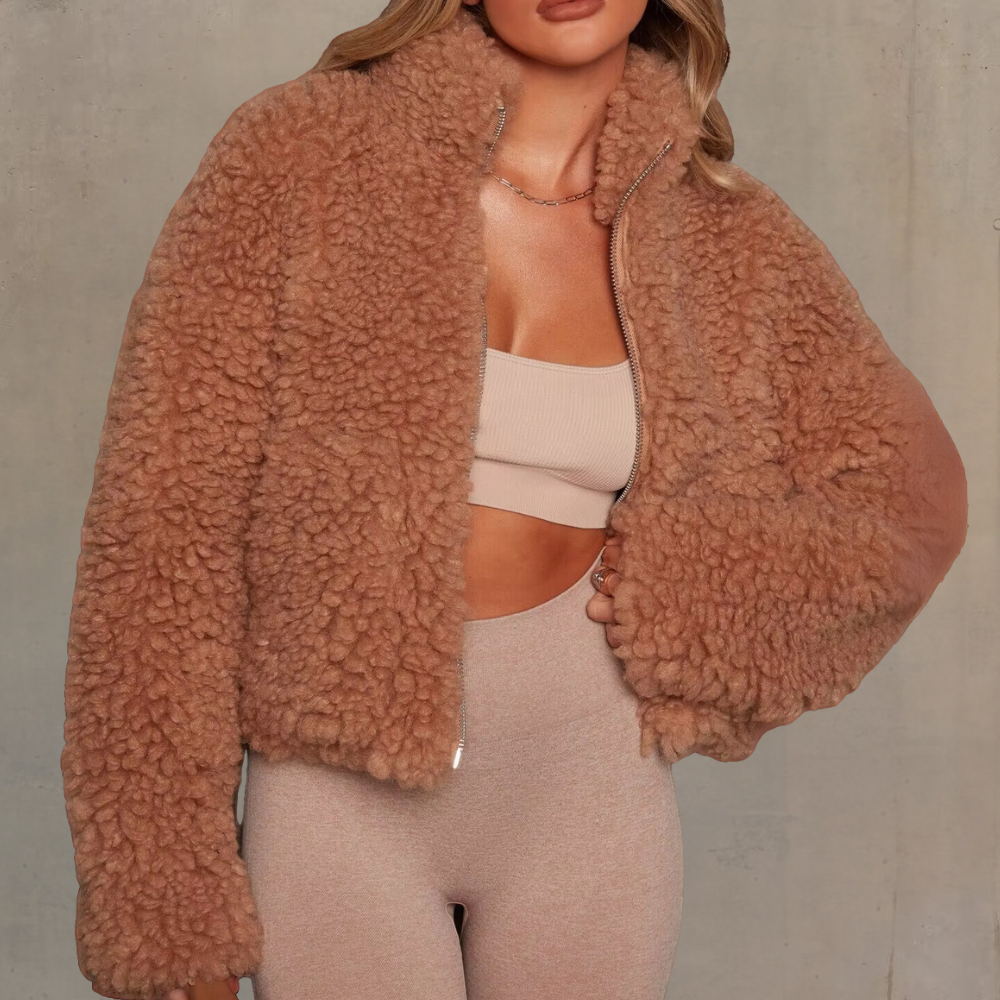 Frau in brauner Teddyfelljacke, beige Top und Leggings, modische Winterkleidung, gemütlich.