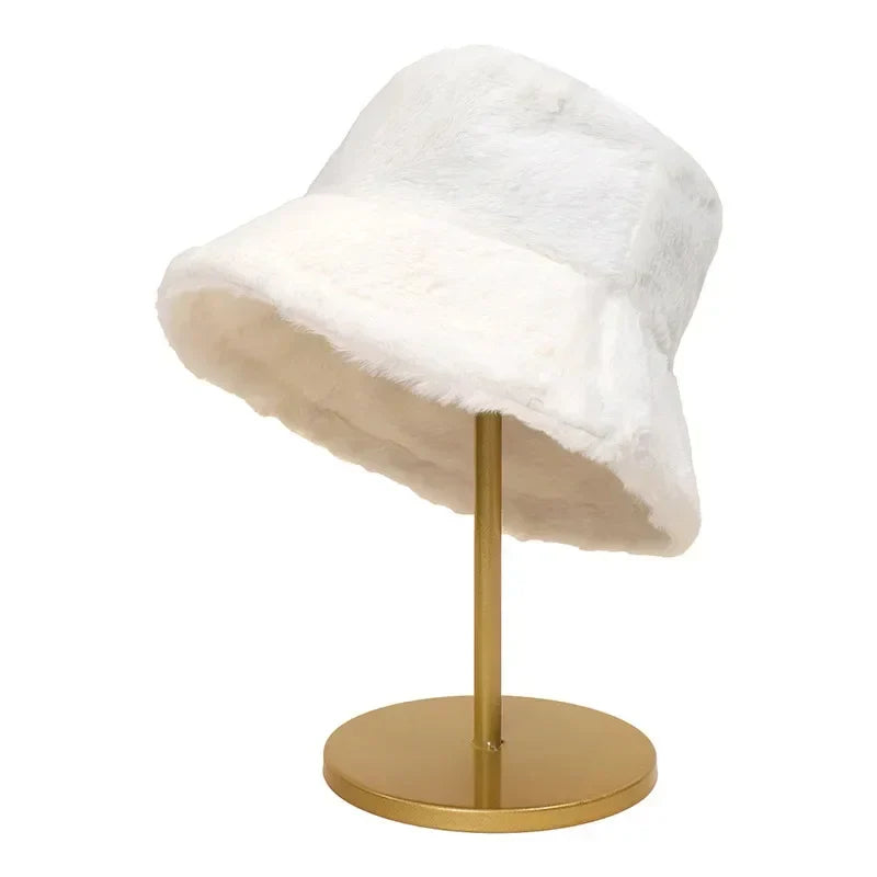 Weißer Kunstpelz-Bucket-Hut auf goldenem Ständer, modisches Accessoire, Wintermode.