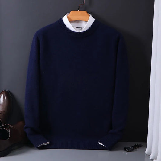 Dunkelblauer Herrenpullover aus Wolle, elegant, auf Holzkleiderbügel vor grauem Hintergrund.
