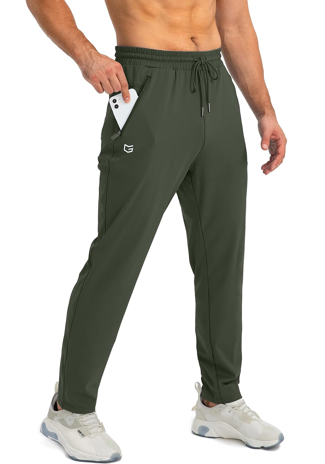 Grüne Herren-Sporthose mit Taschen, elastischer Bund, ideal für Fitness und Freizeit.
