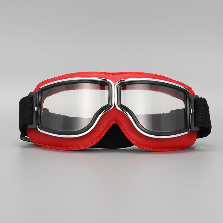 Fliegerbrille mit roter Lederpolsterung, Chromrahmen und klaren Gläsern, Vorderansicht mit schwarzem elastischem Band. 10
