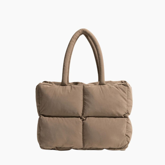 Beige gesteppte Handtasche aus Stoff mit Tragegriffen, modisches Accessoire für Damen.