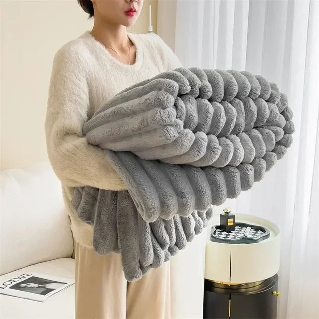 Frau hält graue, flauschige Decke, Wohnzimmer, gemütlich, weiches Material, Heimdekoration.