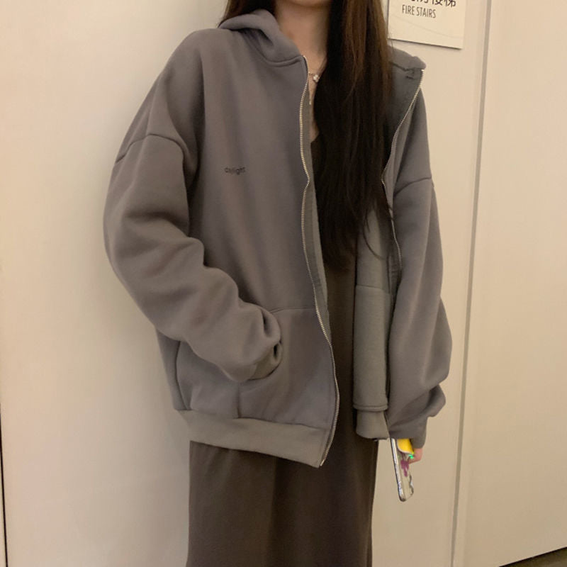 Frau in grauem Kapuzenpullover, lässiger Stil, gemütliche Mode, Herbstbekleidung.
