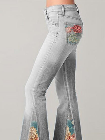Graue Schlaghose Damen mit Blumenstickerei auf Taschen, modische Jeans, Vintage-Stil.