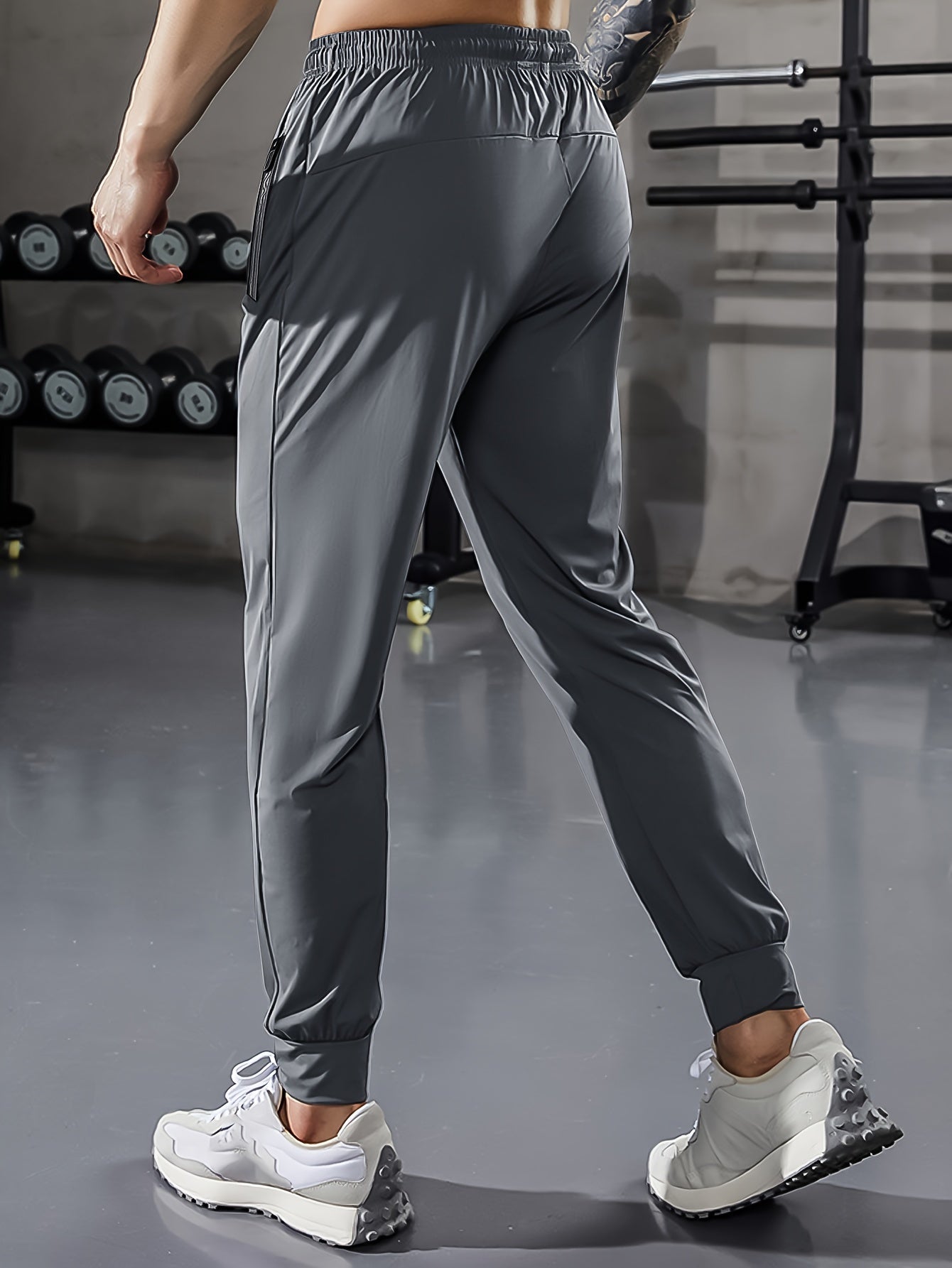 Graue Herren-Trainingshose, elastisch, atmungsaktiv, Fitnessstudio, Sportbekleidung.