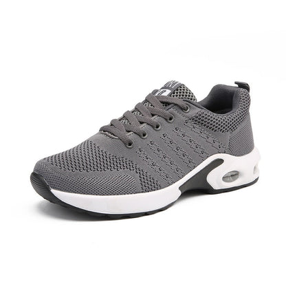 Grauer Sportschuh, atmungsaktives Mesh, rutschfeste Sohle, ideal für Laufen und Fitness.