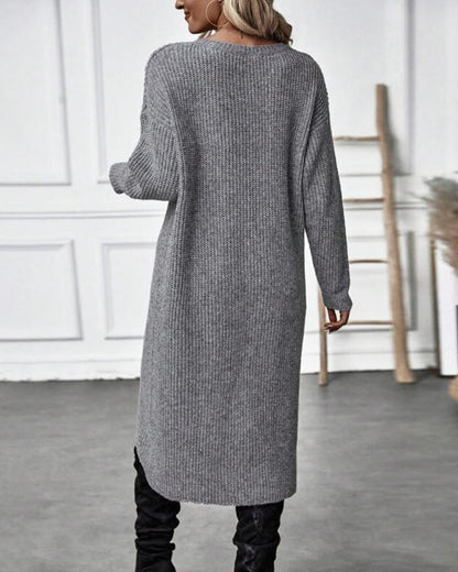 Frau in grauem Strickkleid, langärmelig, modisch, Herbstmode, schwarze Stiefel, Rückansicht.