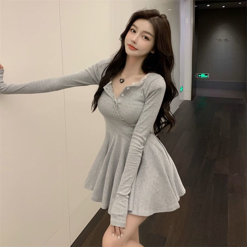 Frau in grauem, langärmligem Skaterkleid, modisch, elegant, Freizeitkleidung, Innenraum.