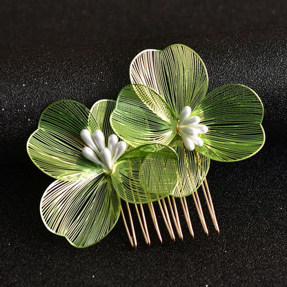 Grüner Haarkamm mit filigranen Blumen, goldene Zinken, elegantes Accessoire für Hochzeiten.
