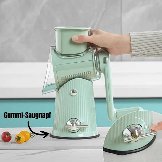 Handkurbel-Gemüseschneider mit Gummi-Saugnapf, mintgrün, auf Küchenarbeitsplatte.