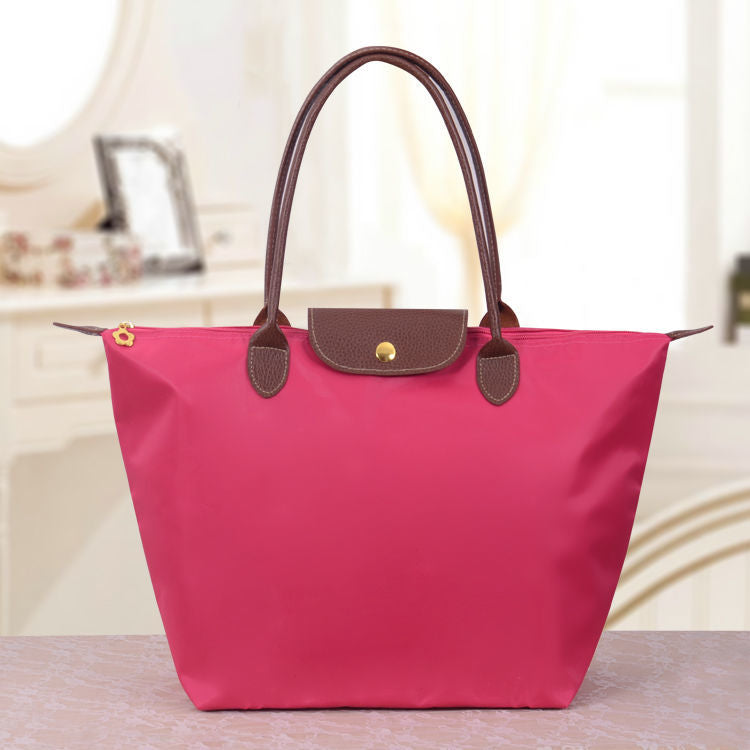 Rosa Damenhandtasche aus Leder, elegantes Design, modisches Accessoire, Alltagsgebrauch.
