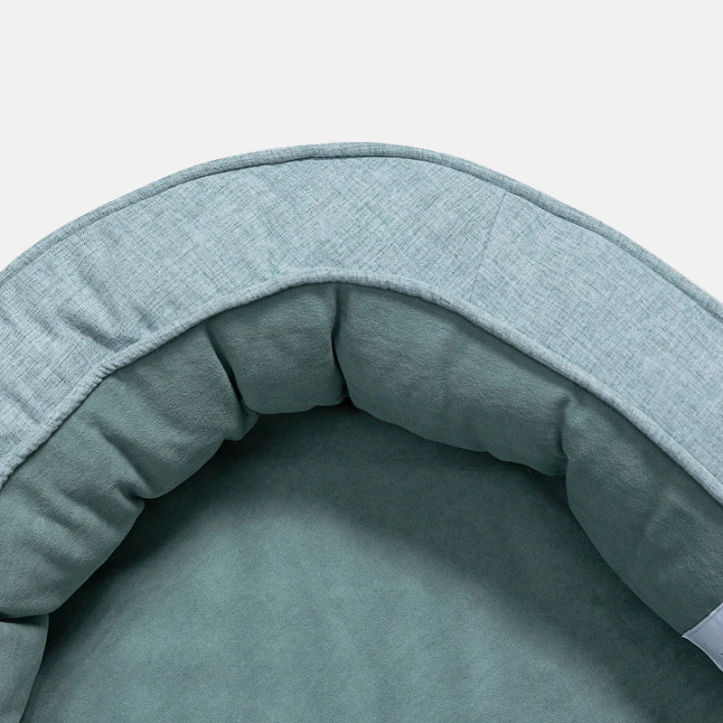Graues Hundebett aus Stoff, rund, gemütlich, ideal für Haustiere, waschbar, langlebig.