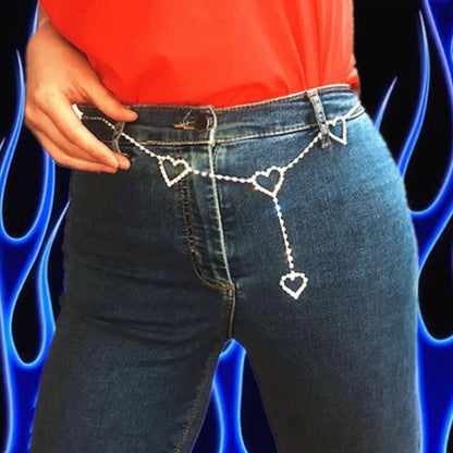 Silberne Herz-Gürtelkette an blauer Jeans, modisches Accessoire für Damen.