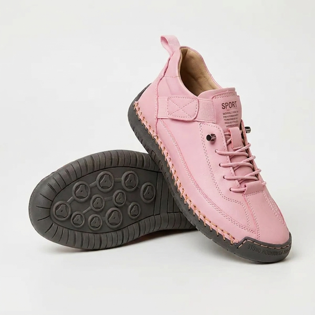 Rosa Sneaker mit orangefarbener Handnaht und dunkelgrauer Sohle, daneben ein Schuh mit sichtbarer Noppensohle. 14