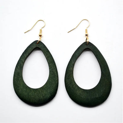 Grüne Holzohrringe, tropfenförmig, mit goldenen Haken, modisches Accessoire.