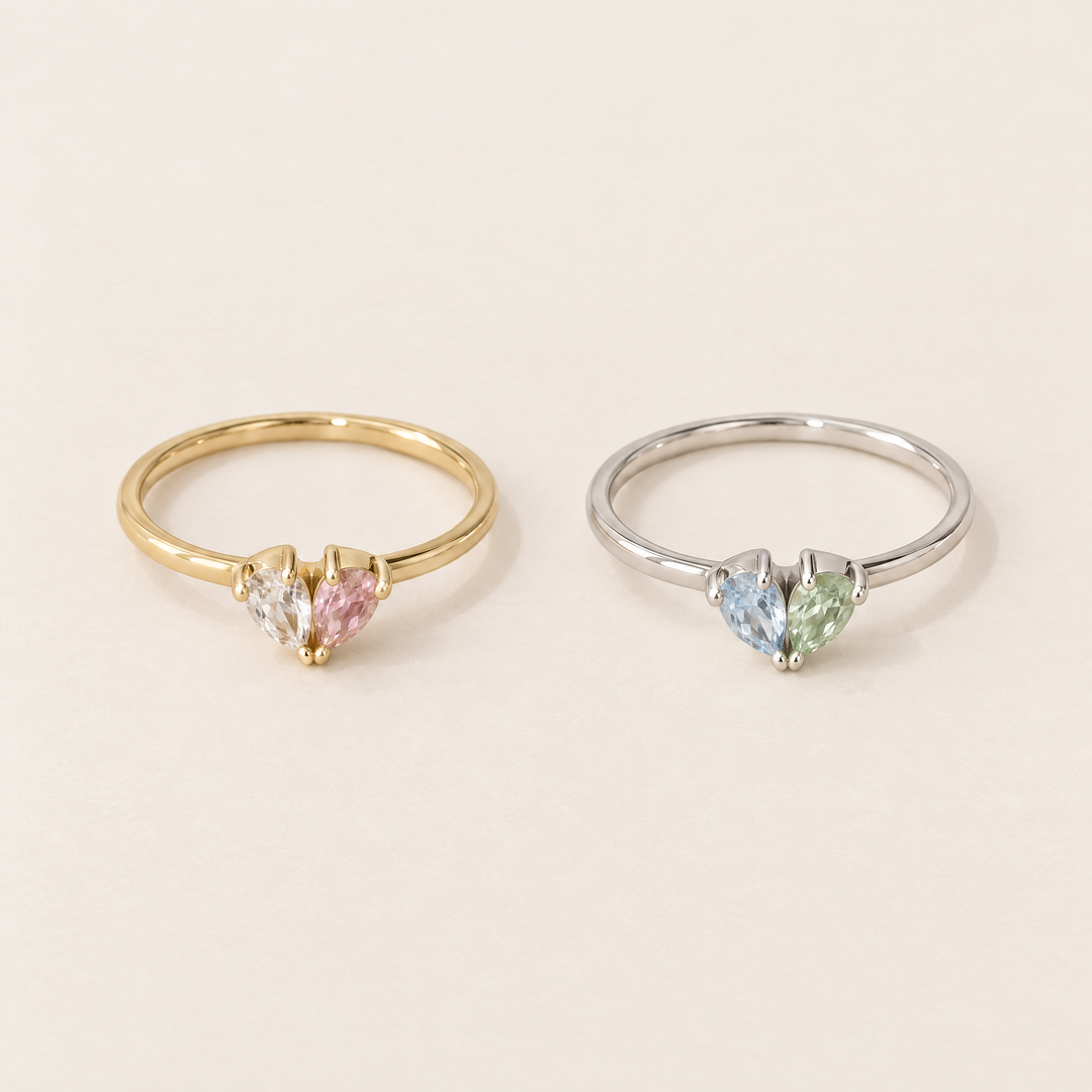 Zwei Ringe nebeneinander: links goldfarben mit klarem und rosa Stein, rechts silberfarben mit hellblauem und hellgrünem Stein. 4