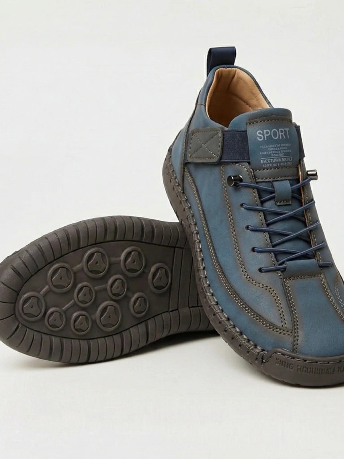 Blaugraue Sneaker mit marineblauen Schnürsenkeln, daneben die graubraune Sohle mit Noppen 8