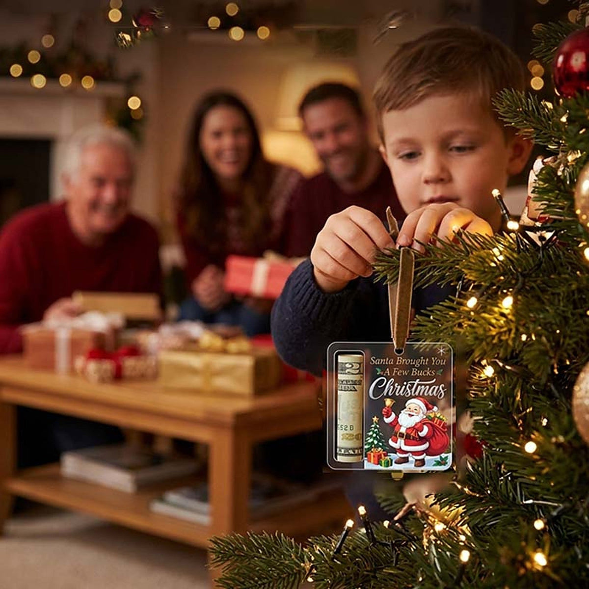 Kind hängt den Anhänger mit Geldrolle an einen beleuchteten Tannenzweig, dahinter sitzt die Familie bei Geschenken. 11