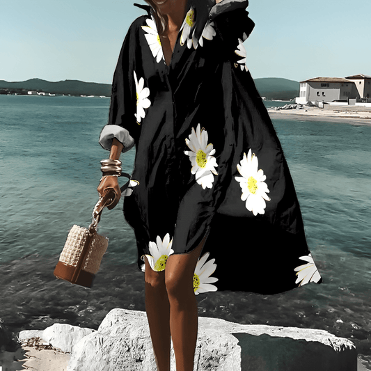 Frau in schwarzem, geblümtem, knielangem Kleid am Meer, Sommermode, Elle Vire.