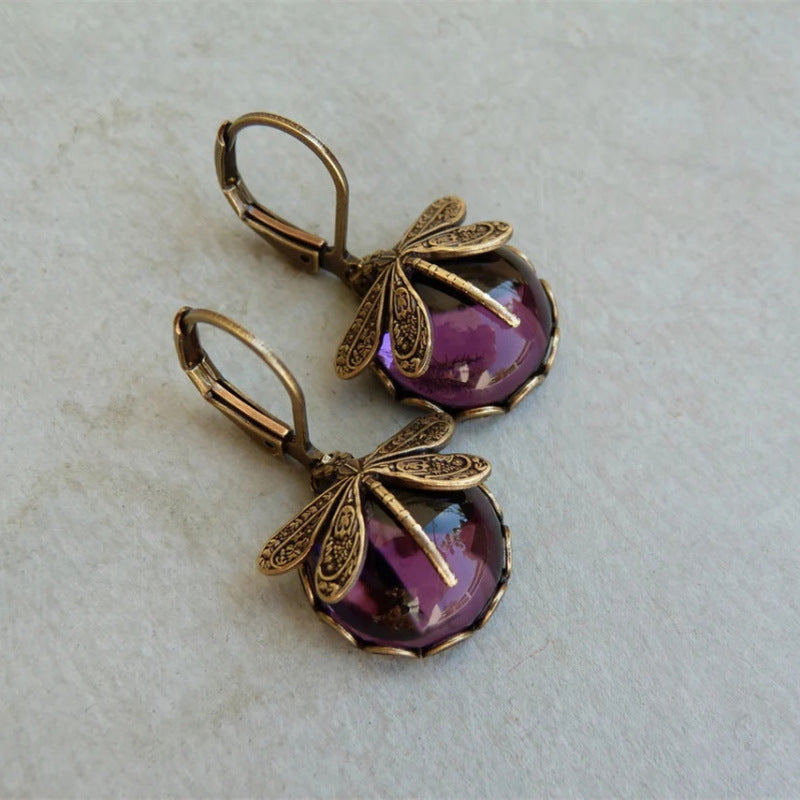 Vintage Ohrringe mit Libellenmotiv, bronzefarben, lila Glasstein, handgefertigter Schmuck.