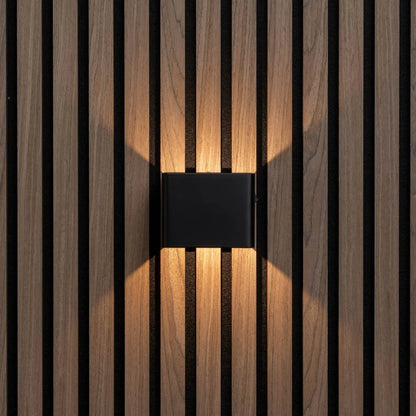 Frontansicht der schwarzen Wandleuchte an Holzlamellenwand, warmes Licht strahlt nach oben und unten 5