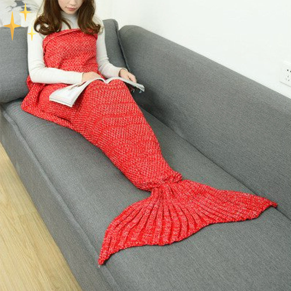 Frau in roter Meerjungfrau-Decke auf Sofa, Strickdecke, gemütlich, Geschenkidee, Wohnzimmer.