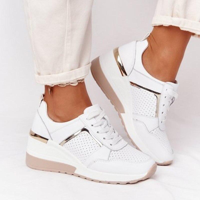 Weiße Damen-Sneaker mit Keilabsatz, perforiertem Leder, goldenen Akzenten, bequem.