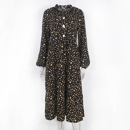 Schwarzer Damen-Jumpsuit mit weißen Punkten, lange Ärmel, Knopfleiste, modisch, elegant.