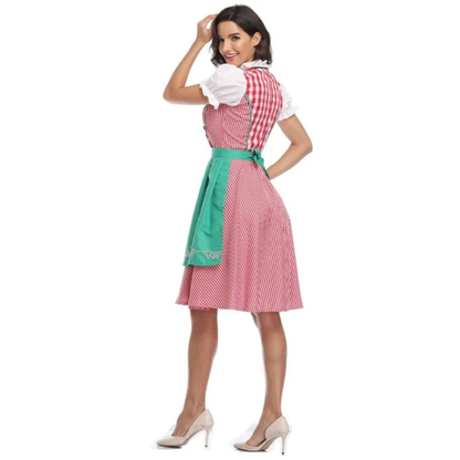 Rückansicht des Dirndls mit rot-weiß kariertem Rücken und grüner Schürze mit Schleife, Model schaut lächelnd über die Schulter. 10