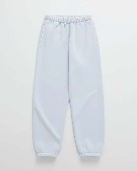 Hellblaue Jogginghose mit Gummibund, seitlichen Taschen und gerafften Beinabschlüssen, flach ausgelegt. 9
