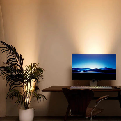 Moderner Schreibtisch mit Computer, Holzstuhl und Zimmerpflanze, minimalistische Einrichtung.