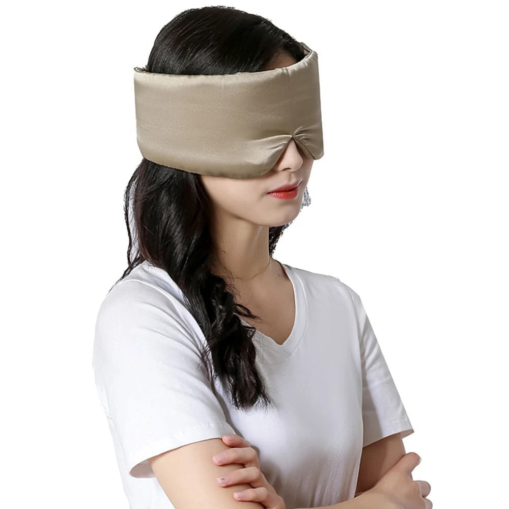 Frau mit beiger Seidenschlafmaske, ideal für Schlaf und Entspannung.